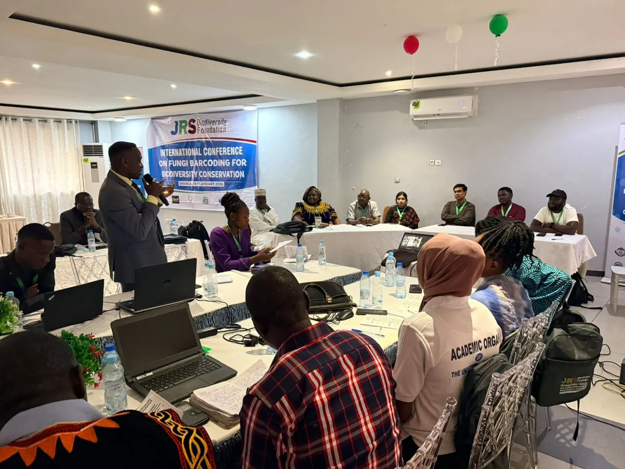 Participant asking a question during panel discussion